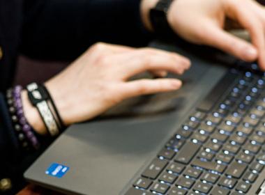 someone typing on a laptop keyboard
