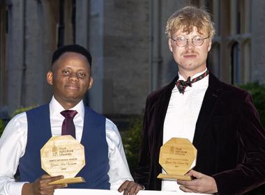 Grand Idea competition winner Ian Muthumbi and runner up Lewis Jackson, holding their awards and a large presentation cheque