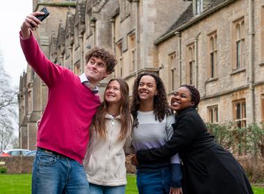 A group of students taking a selfie outside the main RAU building