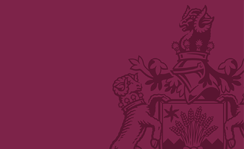 Royal Agricultural University logo with burgundy background