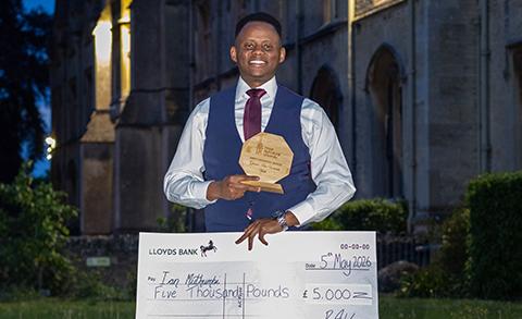 Ian Muthumbi holding a presentation cheque and Grand Idea 2026 award